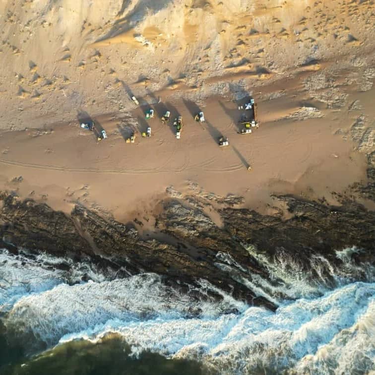 Drone footage taken during 4x4 tours Namibia showing cars parked at the beach