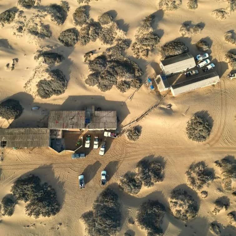 Drone footage of dune landscapes with cars parked taken during Luderitz to Walvis Bay 4x4 Tours with Armand Basson